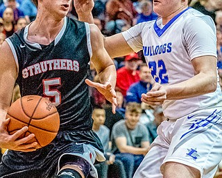 Struthers' Carson Ryan looks to pass around Lakeview defender Drew Munno during the Division II District Title game in Boardman on Saturday. Lakeview won 72-59.