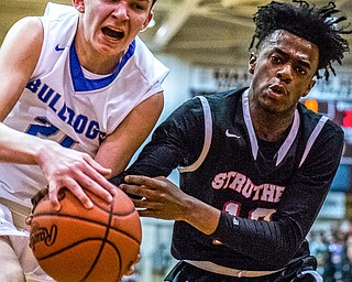 Lakeview's Jeff Remmick and Struthers' Brandon Washington fight for possession of a loose ball during the Division II District Title game in Boardman on Saturday. Lakeview won the crown 72-59...Photo by Dianna Oatridge.