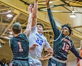 Lakeview's Drew Munno splits through Struthers' defenders Isiah Torrance (L) and Brandon Washington (R) on the way to the hoop Lakeview's 72-59 win at Boardman on Saturday in the Division II District Final...Photo by Dianna Oatridge.