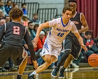 Lakeview's AJ McClellan splits Struthers defenders Tyrese Hawkins (left) and Kevin Traylor (right) as he dribble upcourt during the Division II District Title game in Boardman on Saturday. Lakeview won 72-59...Photo by Dianna Oatridge.