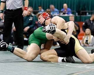 Canfield's David Crawford, top, works against St. Vincent-St. Mary's David Heath in a 182 pound championship match during the Division II Ohio state wrestling tournament at the Ohio State University Saturday, March 10, 2018. Crawford won 5-3. (Photo by Paul Vernon)