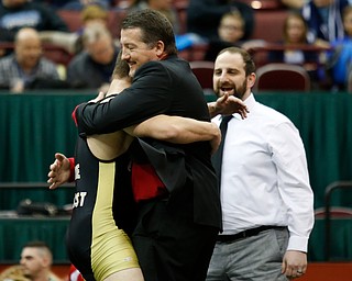 Canfield's David Crawford, left, gets a hug from his father David as his coach Steve Pitts looks on following Carwford 5-3  182 pound championship match win over St. Vincent-St. Mary's David Heath during the Division II Ohio state wrestling tournament at the Ohio State University Saturday, March 10, 2018. (Photo by Paul Vernon)