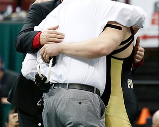 Canfield's Tyler Stein, right, hugs coaches Steve Pitts, center, and David Crawford following his 7-3  220 pound championship match win over Maumee's Brandon Phillips during the Division II Ohio state wrestling tournament at the Ohio State University Saturday, March 10, 2018. (Photo by Paul Vernon)