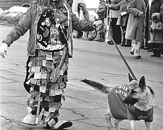 A German Shepherd wearing the Irish green?  Thomas Davison, an Aut Mori Grotto clown, has them all fooled as he walks his "Irish Setter."..Photo taken March 11, 1984...Photo is by Robert K. Yosay.