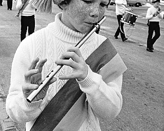 Kevin Folley of the West Side Irish-American Club Junior Fife and Drum Corps of Cleveland jauntily plays his fife for the crowd.  About half of the 170 units scheduled to perform canceled because of the weather...Photo taken March 11, 1984...Photo by Robert K. Yosay - The Vindicator.