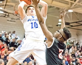 Lakeview’s AJ McClellan (10) puts up a shot as Struthers’ Kevin Traylor defends during a Division II district final Saturday at Boardman High School. Lakeview won 72-59 and secured a regional berth.