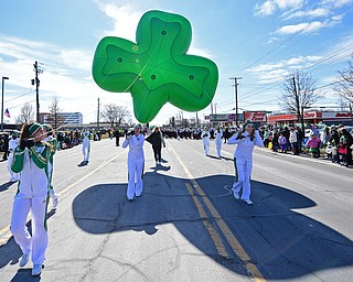 BOARDMAN, OHIO - MARCH 11, 2018: Members of the Ursuline Irish cheerleading team walk with an inflatable shamrock on Market Street at the start of the Mahoning Valley St. Patrick's Day Parade. DAVID DERMER | THE VINDICATOR