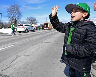 BOARDMAN, OHIO - MARCH 11, 2018: Tyler Divto 6, of Streetsboro waives while saying "Happy Saint Patricks Day" to people marching on Market Street during the Mahoning Valley St. Patrick's Day Parade. DAVID DERMER | THE VINDICATOR