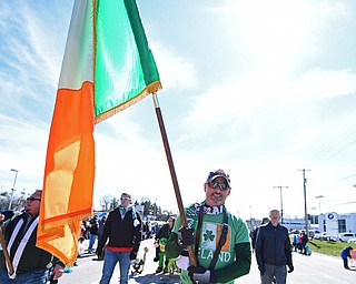 BOARDMAN, OHIO - MARCH 11, 2018: Joe Mccormick of Austiwntown holds the Irish flag while marching on Market Street during the Mahoning Valley St. Patrick's Day Parade. DAVID DERMER | THE VINDICATOR