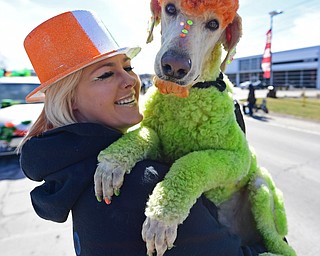 BOARDMAN, OHIO - MARCH 11, 2018: Brienna Donaldson holds Rowdy while marching on Market Street during the Mahoning Valley St. Patrick's Day Parade. DAVID DERMER | THE VINDICATOR