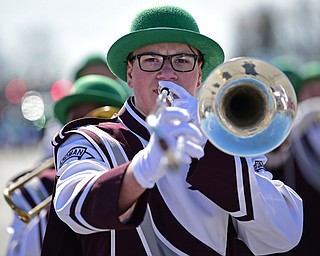 BOARDMAN, OHIO - MARCH 11, 2018: Boardman junior Matthew Welton plays his trombone while marching with the Boardman High School Marching Band on Market Street during the Mahoning Valley St. Patrick's Day Parade. DAVID DERMER | THE VINDICATOR