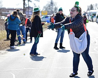 BOARDMAN, OHIO - MARCH 11, 2018: Vindicator reporter Amanda Tonoli throws out some candy while marching on Market Street during the Mahoning Valley St. Patrick's Day Parade. DAVID DERMER | THE VINDICATOR