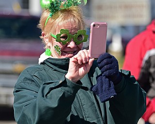 BOARDMAN, OHIO - MARCH 11, 2018: Sue Haynes of Bordman takes a photo on her cell phone on Market Street during the Mahoning Valley St. Patrick's Day Parade. DAVID DERMER | THE VINDICATOR