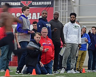 YOUNGSTOWN, OHIO - MARCH 13, 2018: Scouts from different NFL and CFL teams watch as Youngstown State's Alvin Bailey sprints through the finish line during the 40 yard dash during the Youngstown State football pro day, Tuesday morning at the Watts Indoor Facility. DAVID DERMER | THE VINDICATOR