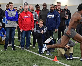 YOUNGSTOWN, OHIO - MARCH 13, 2018: Scouts from different NFL and CFL teams watch as Youngstown State's Damoun Patterson sprints through the finish line during the shuttle run during the Youngstown State football pro day, Tuesday morning at the Watts Indoor Facility. DAVID DERMER | THE VINDICATOR