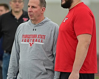 YOUNGSTOWN, OHIO - MARCH 13, 2018: Youngstown State's Justin Spencer talks with head coach Bo Pelini during a shuttle drill during the Youngstown State football pro day, Tuesday morning at the Watts Indoor Facility. DAVID DERMER | THE VINDICATOR