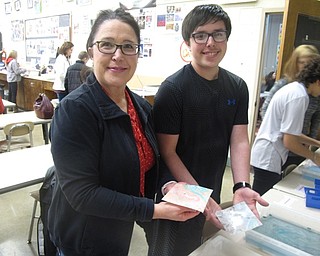 Neighbors | Zack Shively.Families went to Glenwood Junior High School on Jan. 18 for their STEAM night where they could do activities together. Pictured, a mother and son created suminagashi artworks using ink that floats in water.