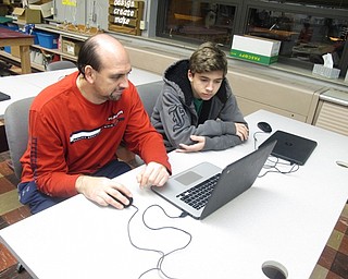 Neighbors | Zack Shively.Families could use the technology department's 3D printer during the night. They used the computer to design objects for the printer to create.