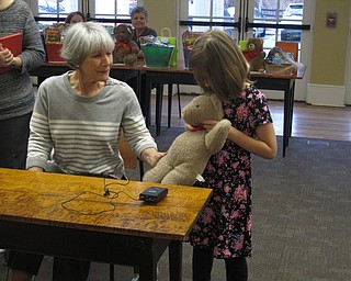 Neighbors | Zack Shively.Children talked to author Linda Brady Smith about their teddy bears after she read her story. Pictured, Charlotte Thorne showed her teddy bear to Smith.