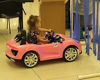 Karina, of Boardman, happily drove her modified pink car through the obstacle course at the Go Baby Go build at the Mahoning County Career and Technical Center on Feb. 24.