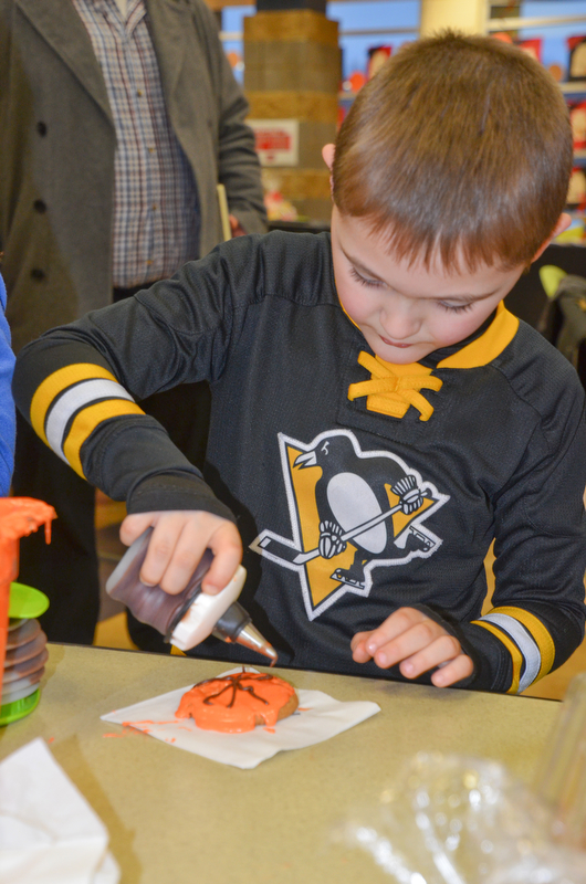 Mason Dugan, kindergarten, decorates a basketball cookie at Campbell Community Night at Campbell K-7 School on Thursday, March 15, 2018...Photo by Scott Williams - The Vindicator.