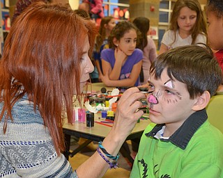 Oliver Ruediger, 2nd grade, gets his face painted by Maria Rosensteel, 7th grade teacher, at Campbell Community Night at Campbell K-7 School on Thursday, March 15, 2018...Photo by Scott Williams - The Vindicator.