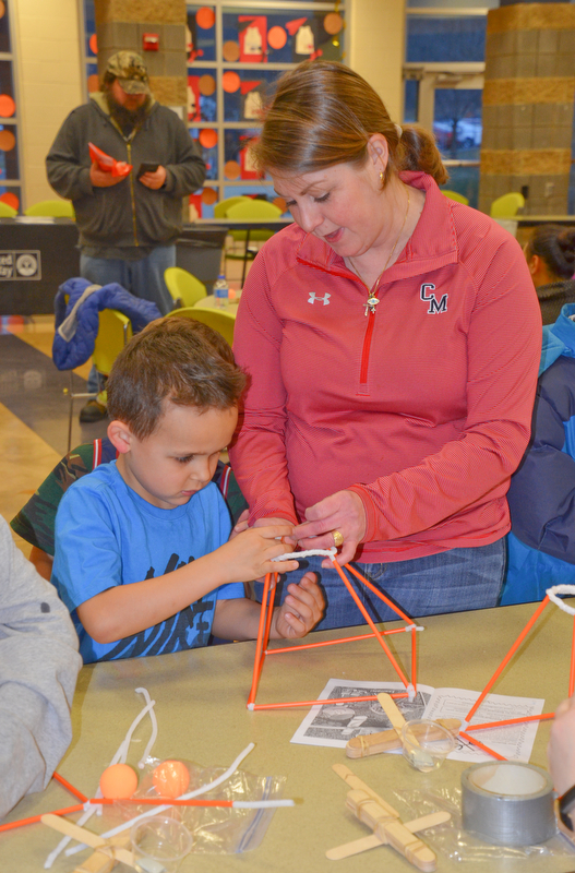 Third-grade teacher Kim Kolidakis helps kindergarten student Frankie Rossodivita with an arts-and-crafts activity at Campbell Community Night at Campbell K-7 School on Thursday, March 15, 2018...Photo by Scott Williams - The Vindicator.