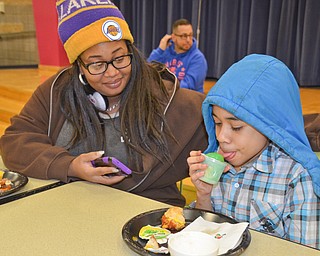 DaVon Curry, 5th grade, enjoys a frozen-ice treat while his mother, Rochell Myrick, enjoys time with her son at Campbell Community Night at Campbell K-7 School on Thursday, March 15, 2018...Photo by Scott Williams - The Vindicator.