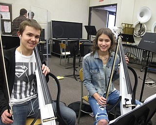 Neighbors | Zack Shively.The Project Mayhem orchestra features a mix of traditional string instruments and electric rock 'n' roll instruments, along with electric version of the string instruments. Pictured are Justin Olsen and Maizie Reese with their electric cellos at band practice.