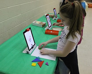Neighbors | Abby Slanker.A Hilltop Elementary School third-grade student solved a puzzle using the Osmo app on an iPad at the technology station during the school’s annual STEM Week on March 8.