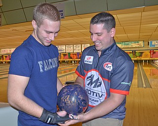 Seth Welch, left; Austintown Fitch senior, receives some help from pro bowler Ryan Ciminelli, from Buffalo, NY, at Bell Wick Bowling Alley in Hubbard, Ohio on March 16, 2018...Photo by Scott Williams - The Vindicator.