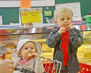 Benjamin Strickland, right, age 3, and his sister Brooklyn Strickland, age 1, enjoy some yummy free samples at the 16th Annual White House Weekend at White House Fruit Farm in Canfield on Saturday, March 17, 2018...Photo by Scott Williams - The Vindicator