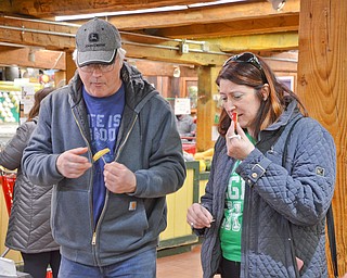 Tim Phillips and Heidi VanAuker of Canfield try some White House picked apples at the 16th Annual White House Weekend at White House Fruit Farm in Canfield on Saturday, March 17, 2018...Photo by Scott Williams - The Vindicator.