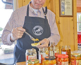Tony Arite, from Toledo, prepares a sample of Monteleone Peppers at the 16th Annual White House Weekend at White House Fruit Farm in Canfield on Saturday, March 17, 2018...Photo by Scott Williams - The Vindicator.