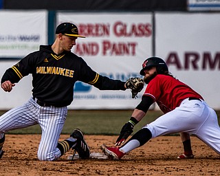 THE VINDICATOR | DIANNA OATRIDGE..Milwaukee's Trevor Schwecke tries to tag out Youngstown State's Jeff Wehler at second base during their Horizon League match-up on Saturday at Eastwood Field.