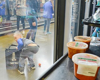 Seth Baker, age 8, picks up Easter eggs in the middle of the frozen food aisle at Rulli Brothers in Boardman on March 18, 2018.  Seth attended with his mother Christine Baker, of Boardman.

Photo by Scott Williams - The Vindicator