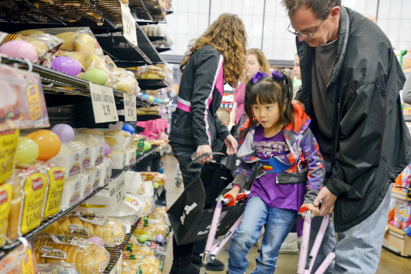 Shi Yu DeBow, age 6, hunts for Easter eggs in the middle of the bread aisle of Rulli Brothers in Boardman on Sunday, March 18, 2018.  Shi Yu her helped by her father Dan DeBow of Poland.

Photo by Scott Williams - The Vindicator.