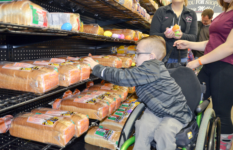 Joshua Kurth, age 8, hunts for eggs in the middle of the bread aisle in Rulli Brothers in Boardman on March 18, 2018.  Joshua attended with his father, Josh, of Poland, and was helped by his sister Emma, age 13, and Ella, age 10.

Photo by Scott Williams - The Vindicator