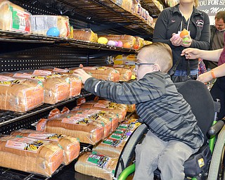 Joshua Kurth, age 8, hunts for eggs in the middle of the bread aisle in Rulli Brothers in Boardman on March 18, 2018.  Joshua attended with his father, Josh, of Poland, and was helped by his sister Emma, age 13, and Ella, age 10.

Photo by Scott Williams - The Vindicator