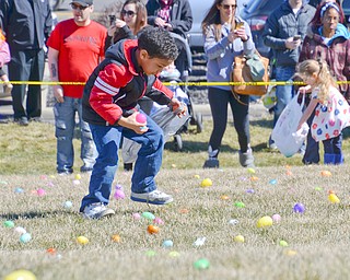 Juwan Ditosto, age 6, in the red and black jacket, grabs some eggs at an Easter egg hunt hosted by Rulli Brothers in Boardman on Sunday, March 18, 2018.  Ditosto was brought to the event by his mom Jessica Bell, of Youngstown...Photo by Scott Williams - The Vindicator.