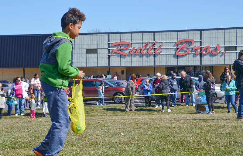 Isaiah Franklin, age 9, hunts for one last egg at Rulli Brothers in Boardman on March 18, 2018.  Franklin was brought to the event with is neighbor Christy Christoff, of Boardman.

Photo by Scott Williams - The Vindicator.