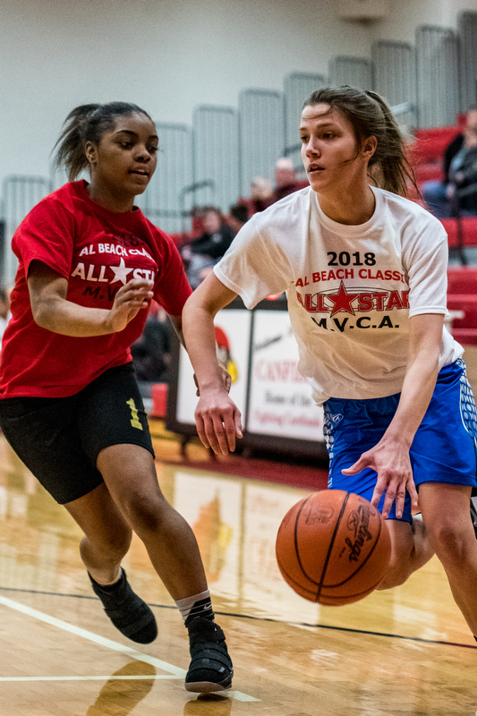 Warren Harding's Brayleonna Woods guards Jackson Milton's Michaelina Terranova as she drives toward the basket during the Al Beach All-Star Classic held at Canfield High School on Tuesday.