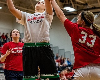 West Branch's Natalie Zuchowski shoots over the defense of Champion's Megan Turner as Brookfield's Tori Sheehan looks on during the Al Beach Classic held at Canfield High School on Tuesday.