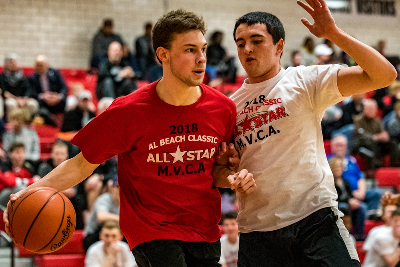 LaBrae's Aaron Iler drives the baseline against defensive pressure from West Branch's Michael Boosz during the Al Beach All-Star Classic at Canfield High School on Tuesday.