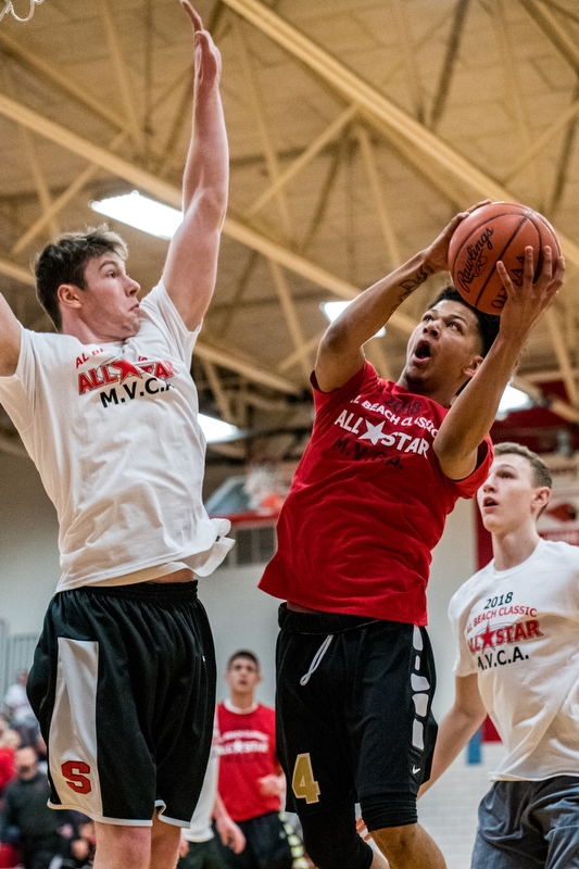 Warren G. Harding's Chris Hughes shoots over Struthers' Ryan Leonard as Boardman's Holden Lipke looks on during the Al Beach All-Star Classic on Tuesday at Canfield High School...?