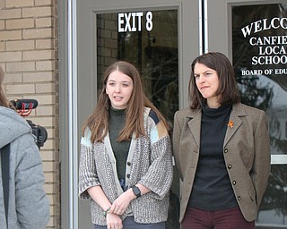 William D Lewis The Vindicator Canfield HS 11th graders Sydney Karlock, left, and Gabriella Sammarone are videoed by 12 th grader Emma Kadilak outside Canfield BOE office 3-21-18. Several students attended the BOE meeting to voice concerns about student saftey.