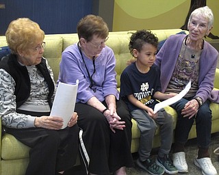 Neighbors | Zack Shively.Kathy Boosinger, Activities Director at The Inn at Poland Way, said she enjoyed having the elementary students coming to visit. She said it helped some residents become more social. Pictured, student Eric Moorman bonded with the residents.