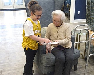 Neighbors | Zack Shively.The Union Elementary students read “Wilfrid Gordon McDonald Partridge” by Mem Fox, which follows about a young child who befriends residents at an assisted living facility. The Union Elementary students followed this example and visited The Inn at Poland Way. Pictured, Ava Flood and a resident talk about a students' answer to an assignment.