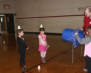 Neighbors | Abby Slanker.A C.H. Campbell Elementary School second-grade student learned about air pressure as she tried to knock cups off her fellow students’ heads by forcing air through a container during the school’s annual STEM Week.