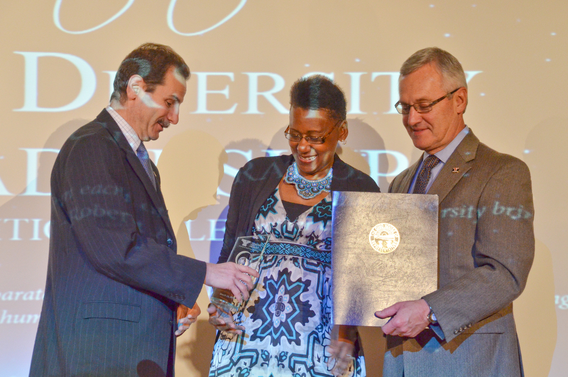 Dr. Sherri Harper Woods is handed her Campus Leadership award from YSU Provost VP Academic Affairs Martin Abraham as YSU President James P. Tressel stands with an award from the State of Ohio at the Diversity Leadership Recognition Dinner at Stambaugh Tyler Grand Ballroom on Thursday, March 22, 2018.

Photo by Scott Williams - The Vindicator